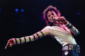 FILE - In this Feb. 24, 1988 file photo, Michael Jackson leans, points and sings, dances and struts during the opening performance of his 13-city U.S. tour, in Kansas City, Mo. The owners of technology used to create holograms of deceased celebrities on Thursday May 15, 2014, sued Jackson's estate and the producers of Sunday's Billboard Music Awards trying to block any use of their technology to generate a Jackson hologram during the show. (AP Photo/Cliff Schiappa, file)